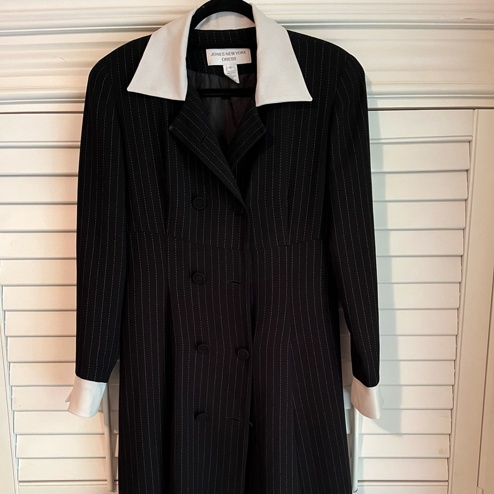 Black with white colar. Fully lined. Can be used as a dress or as an overall.